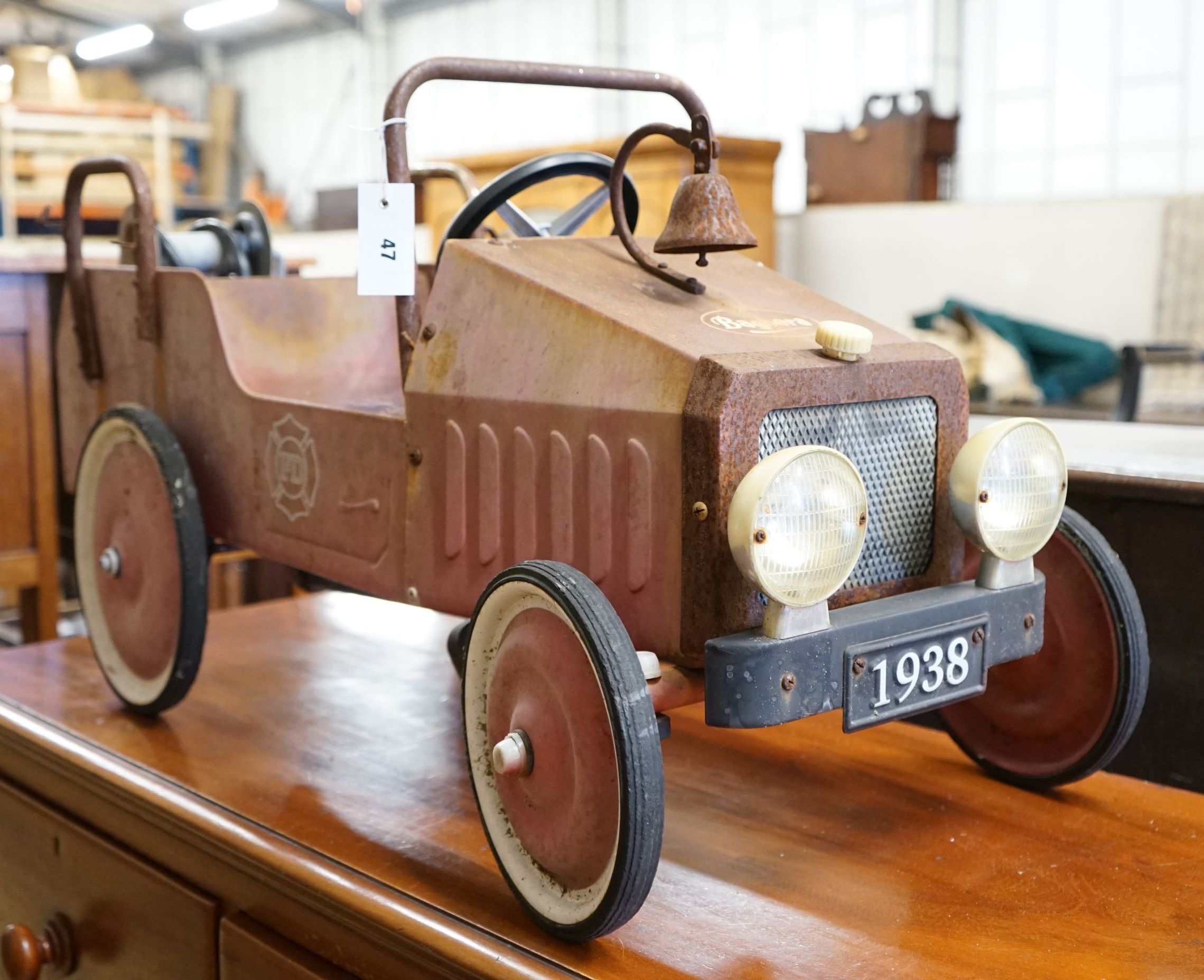 A child's tin plate pedal ride on toy fire engine, length 95cm